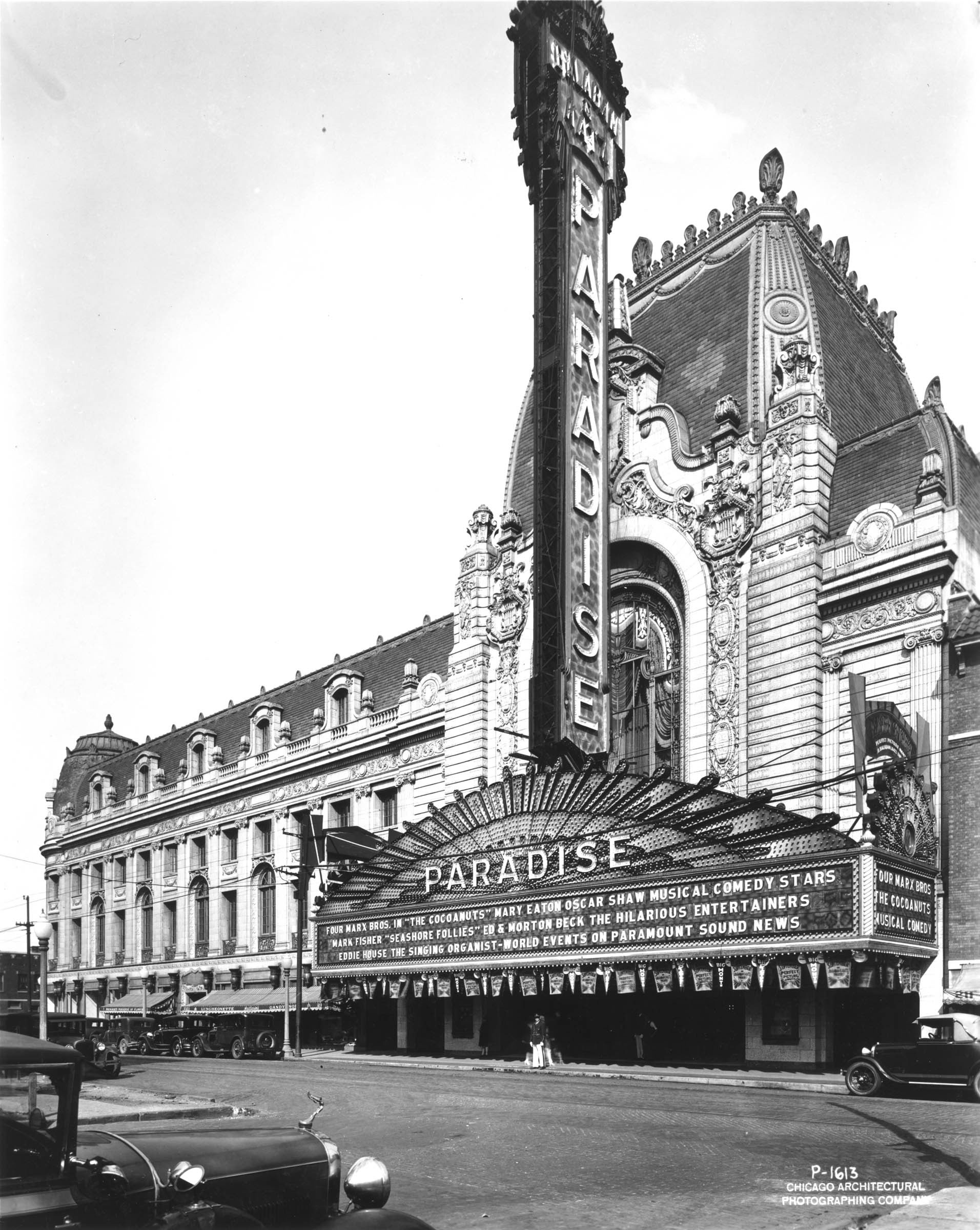 Designed by renowned architect John Eberson, the Chicago Paradise, which opened in 1928, &nbsp;was one of the grandest of the new movie palaces. Dubbed “the World’s Most Beautiful Theater” by Chicago theater entrepreneurs Balaban and Katz, the Paradise had a half-block-long French-inspired Second Empire exterior, featuring a marquee emblazoned with more than 10,000 light bulbs and a seven-story entrance tower. Patrons entered an outer lobby that had a soaring domed ceiling painted with constellations and clouds. In the vast auditorium, a sculpture of three horses pulling a chariot was set above the proscenium arch, appearing to gallop towards the audience.