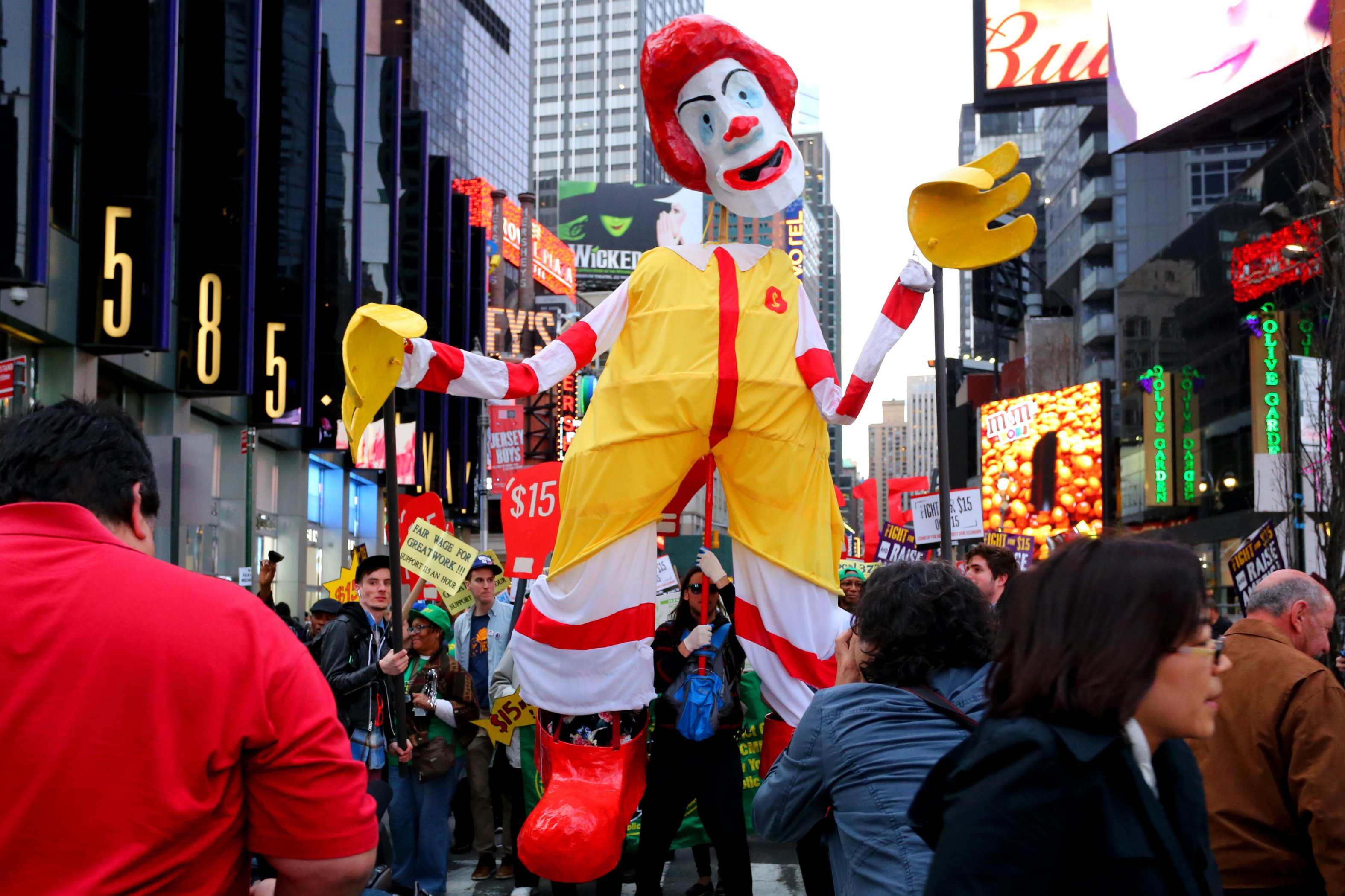 Twisting the fast-food giant McDonald’s “I’m Lovin’ It” slogan into a demand for fair pay, fast-food workers chanted “Fight for &dollar;15” as they marched in New York’s Times Square, carrying a grotesque version of the corporation’s clown mascot (a parody of the familiar Macy’s Thanksgiving Day parade balloon). The April 2015 demonstration joined hundreds of “living wage” protests across the country—and the globe—that year.